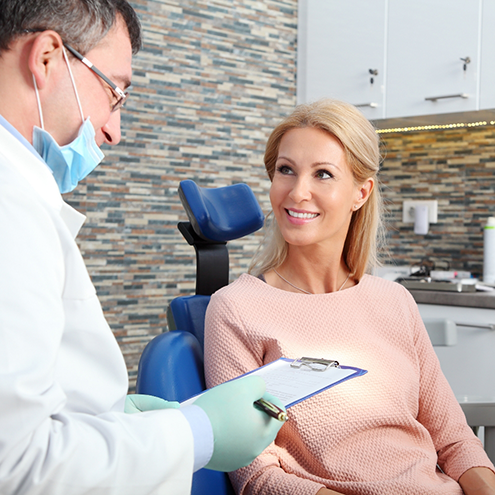 Woman in dental chair smiling at her Reno dentist