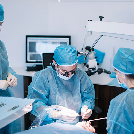 Team of oral surgeons treating a patient