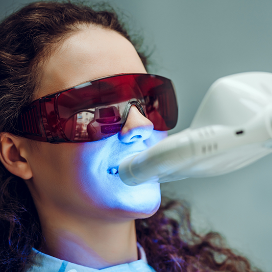 Dental patient having her teeth professionally whitened