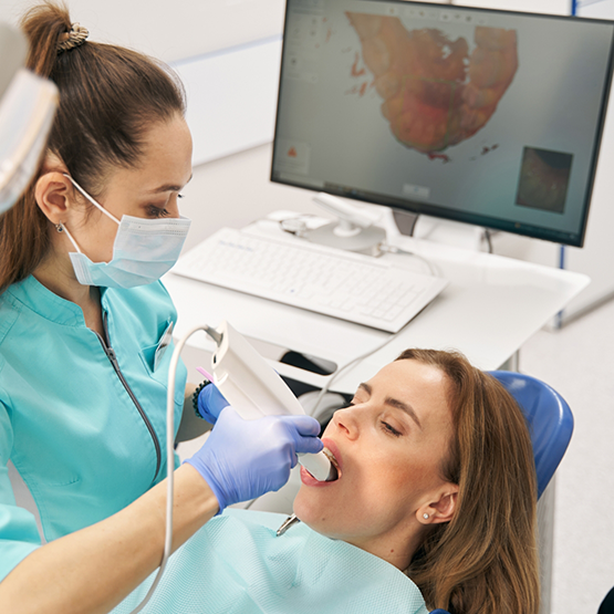 Dental patient having digital impressions of her teeth taken