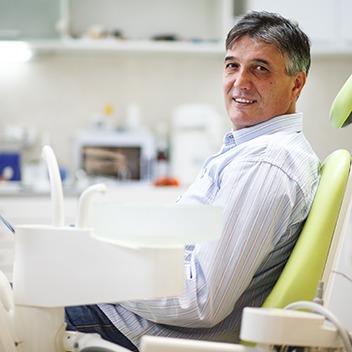 Man smiling while sitting in treatment chair