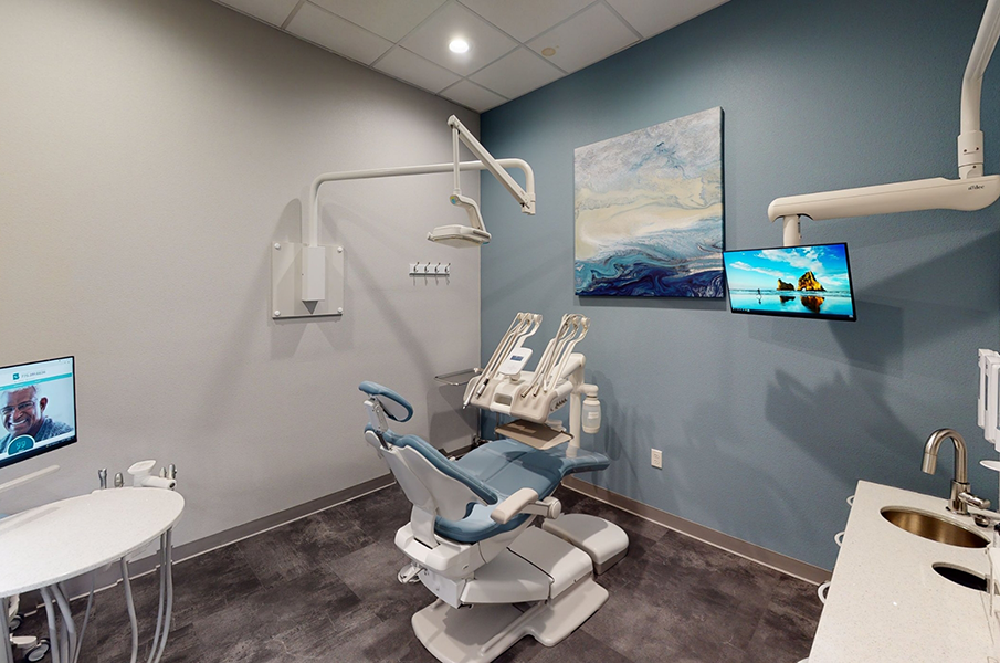 Dental treatment room with beach themed artwork on wall