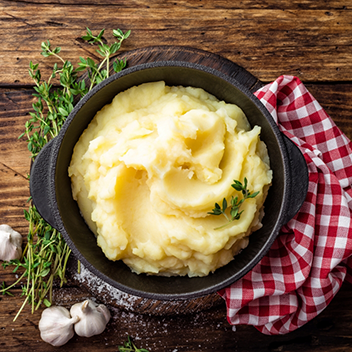 Bowl of mashed potatoes on table