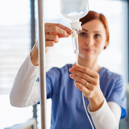 Sedation dentist in Reno adjusting an I V bag