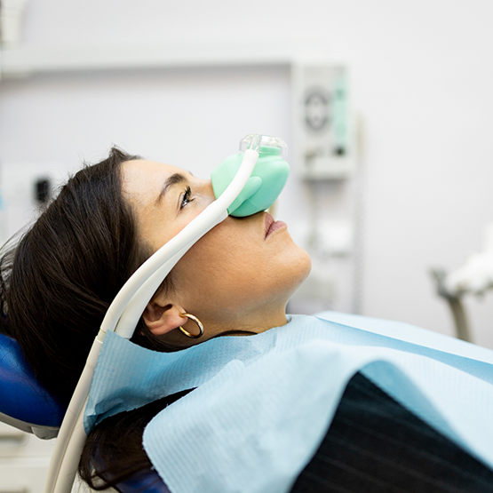 Dental patient wearing a nitrous oxide mask over their nose