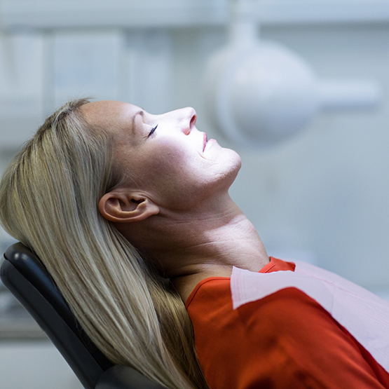 Woman relaxing and leaning back in dental chair